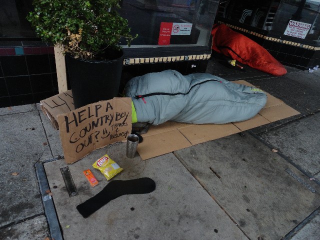 Homeless person with chips crackers and socks from The Little Way Homeless Outreach